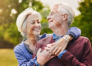 Old couple hug, smile in the park and happiness together outdoor, bonding in nature with love and retirement. Happy, man