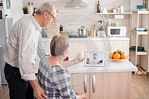 Old couple during online consultation