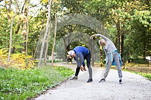 Old couple of pensioners exercuse in park