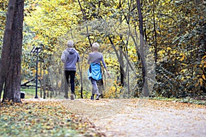 Old couple of pensioners running in park