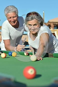 Old couple playing billiard