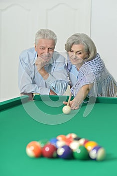 Old couple playing billiard