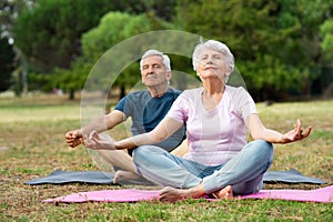 Senior couple doing yoga photo