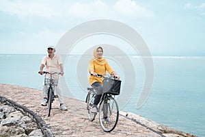 Old couple ride bicycle together