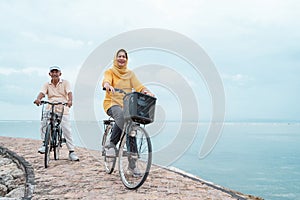 Old couple ride bicycle together