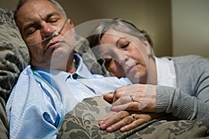 Old couple sleeping together man nasal cannula