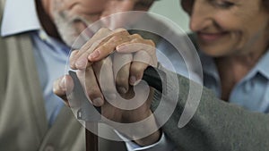 Old couple still holding hands, going through joy and troubles in life together