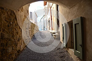 Old covered street in the medieval village of Serres, France photo