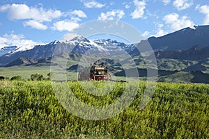 Old covered wagon in the Absaroka Mountains of Wyo photo