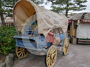 An old Covered wagon and instrument, tool, device, gadget, machine, appliance
