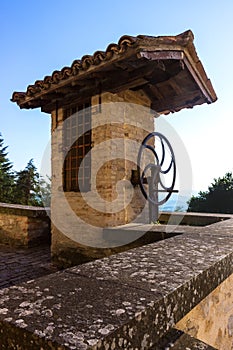 Old covered well in masonry