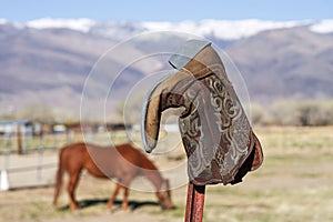 Old Cowboy Boot On Fencepost