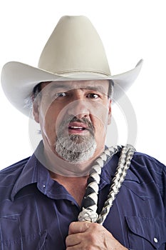 Old cowboy holding bullwhip