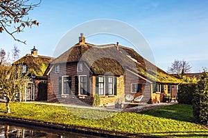 Old cozy house with thatched roof in Giethoorn, Netherlands