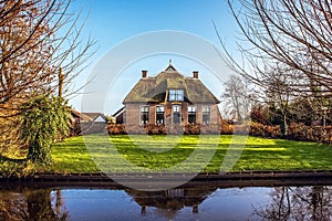 Old cozy house with thatched roof in Giethoorn, Netherlands