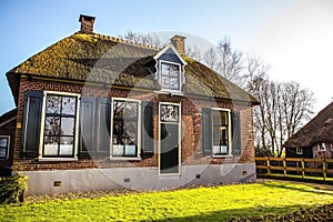 Old cozy house with thatched roof in Giethoorn, Netherlands