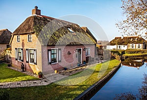 Old cozy house with thatched roof in Giethoorn, Netherlands