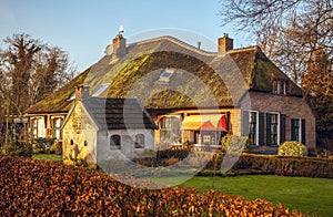 Old cozy house with thatched roof in Giethoorn, Netherlands