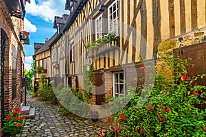 Old cozy street with historic half timbered buildings in the the beautiful town of Honfleur, France