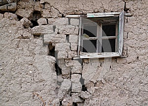 Old cracked adobe wall with window