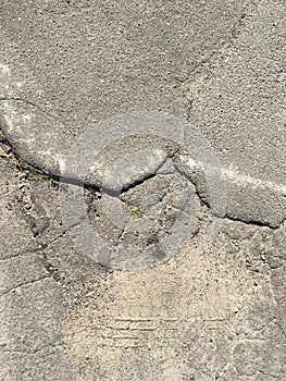 Old cracked asphalt on a sunny day