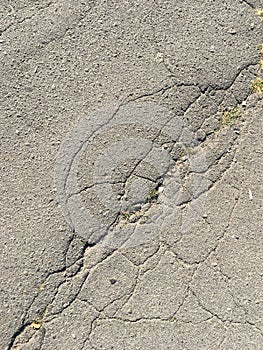 Old cracked asphalt on a sunny day