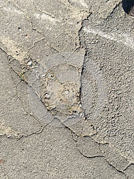 Old cracked asphalt on a sunny day