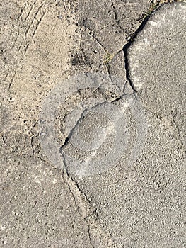 Old cracked asphalt on a sunny day