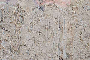 Old cracked clay plaster on brick wall