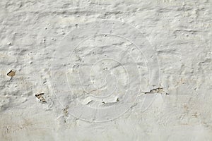 Old and cracked, dilapidated and uneven brick wall, painted with whitening. Texture and background of building wall