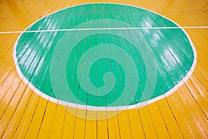 Old cracked floor of the sports hall with markings for basketball