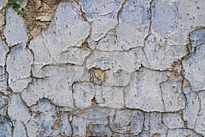 Old cracked parget plaster on a painted blue medieval wall of a house in Lefkara heritage village on Cyprus