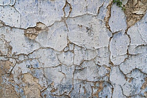 Old cracked parget plaster on a painted blue medieval wall of a house in Lefkara heritage village on Cyprus