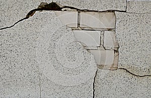 The Old Cracked Wall of a concrete building. A part of the red brick wall was abandoned wall background