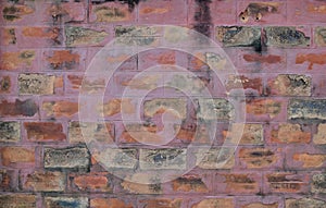 The Old Cracked Wall of a concrete building. A part of the red brick wall was abandoned wall background photo