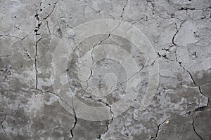 Old cracked wall. faults in the gray wall. a broken wall is falling apart photo