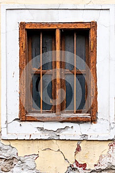 Old cracked wall with a window. window of old house. Old window with brown frame