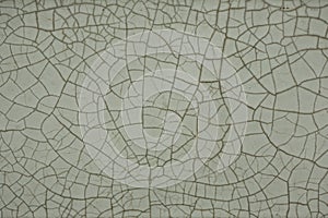 Old cracked white tile, black cracks, texture.