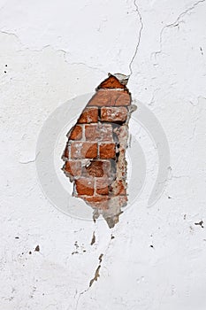 Old cracked white wall with broken plaster