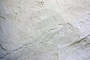 Old cracked whitewashed wall of the wattle and daub house. Close up