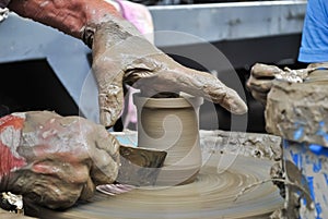 Old craftsman working on a clay pot