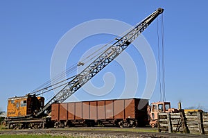 Old crane loading a a car on the railroad