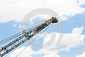 Old Crane or Metal Structure and Sling on Blue Sky Background Side View