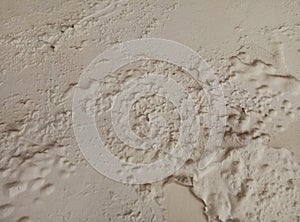 Old creamy wall texture with peeling. Limp and moldy surface. Damage to the wall paint photo