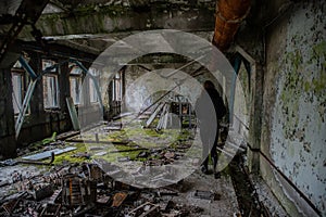 Old. creepy, abandoned ruined room covered in moss in the building located in the Chernobyl ghost town