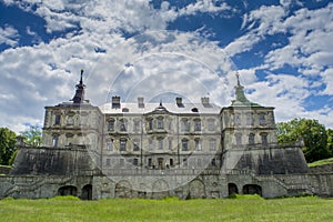 Old creepy dark castle under the blue sky