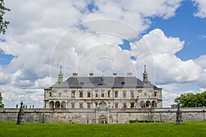 Old creepy huge dark castle surrounded with fence