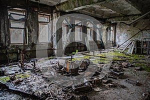 Old. creepy, ruined room covered in moss in the building located in the Chernobyl ghost town