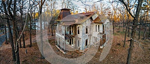 Old creepy wooden abandoned haunted mansion, aerial view