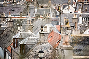 Old croft houses in Cullen, fishing village on Moray Firth, Scotland. Cullen Viaduct in the background, old roofs and chimneys